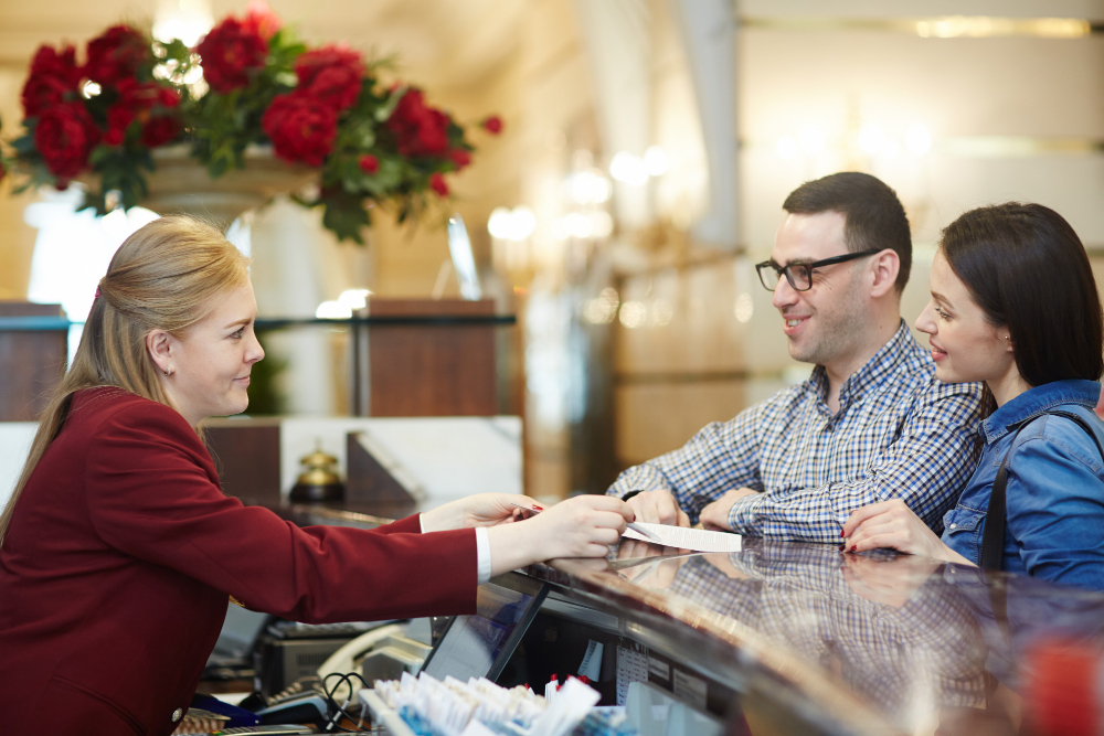 A man and woman are seated at a hotel bar, illustrating the experience offered by a private escort booking service in Los Angeles.