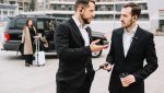 Two business men in formal attire discuss strategies, reflecting their involvement in Commercial Security Services.